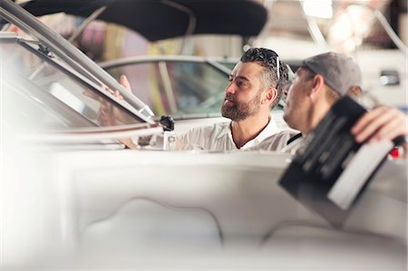 simsearch:649-08715047,k - Two men checking windscreen on boat in repair workshop Stock Photo - Premium Royalty-Free, Code: 614-08946626
