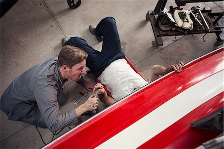 simsearch:614-08148421,k - Overhead view of two men repairing in boat repair workshop Photographie de stock - Premium Libres de Droits, Code: 614-08946647