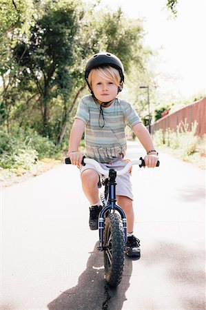 simsearch:614-08487786,k - Portrait of young boy riding bicycle outdoors Stock Photo - Premium Royalty-Free, Code: 614-08984134