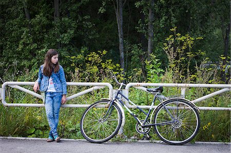 simsearch:614-03902786,k - Teenage girl looking at her bicycle on rural road Photographie de stock - Premium Libres de Droits, Code: 614-08984237