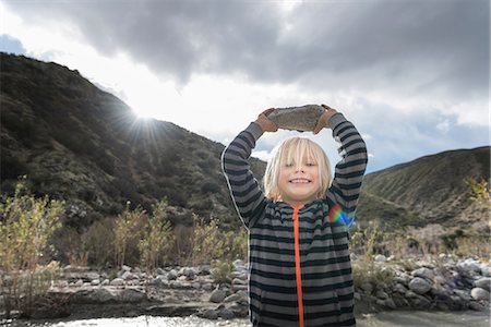 simsearch:400-05025778,k - Portrait of cute boy holding up rock from riverbed Photographie de stock - Premium Libres de Droits, Code: 614-08982782