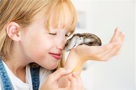 furry preteen - Girl feeding hamster Stock Photo - Premium Royalty-Free, Code: 614-08983108