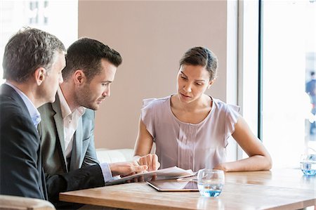 Businessmen and businesswoman working Stock Photo - Premium Royalty-Free, Code: 614-08983134