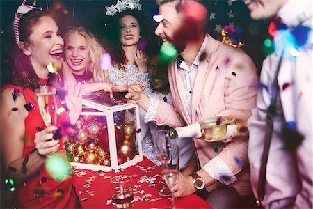 picture of champagne bottle and champagne flute - Group of friends at party, fooling around, pouring drinks Stock Photo - Premium Royalty-Free, Code: 614-08983350