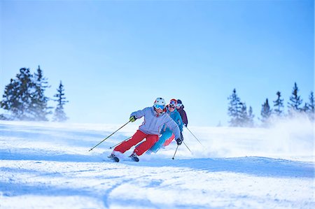 Row of male and female skiers skiing down snow covered ski slope, Aspen, Colorado, USA Stock Photo - Premium Royalty-Free, Code: 614-08983400