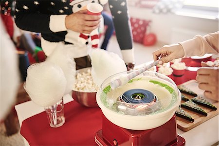 Cropped shot of young woman preparing candyfloss at christmas party Stock Photo - Premium Royalty-Free, Code: 614-08983424