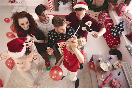 Overhead view of young adult friends dancing at christmas party Stock Photo - Premium Royalty-Free, Code: 614-08983468