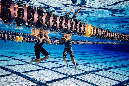 simsearch:614-08870825,k - Swimmer resting on lane divider in pool talking to friend Stock Photo - Premium Royalty-Free, Code: 614-08983504