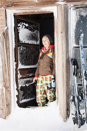 Young woman standing in log cabin snowy doorway, Mount Hood, Oregon, USA Stock Photo - Premium Royalty-Free, Code: 614-08983566