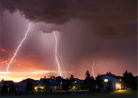 electrical storm - Forked lightning in orange sky over urban area, Aurora, Colorado, United States, North America Stock Photo - Premium Royalty-Free, Code: 614-08983673