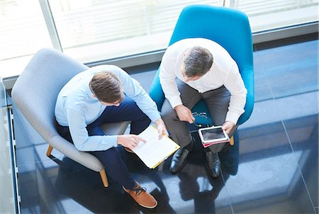 simsearch:649-09061513,k - Overhead view of business men with digital tablet in meeting Stock Photo - Premium Royalty-Free, Code: 614-08983700