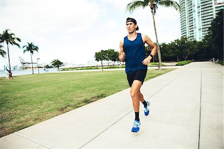 simsearch:614-08392515,k - Young man exercising outdoors, running, South Point Park, Miami Beach, Florida, USA Stock Photo - Premium Royalty-Free, Code: 614-08983838