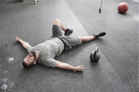 exhausted - Man taking break in cross training gym Stock Photo - Premium Royalty-Free, Code: 614-08983831