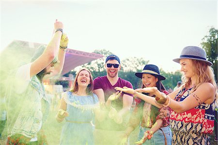 simsearch:649-08824082,k - Young adult friends throwing coloured chalk powder and dancing at festival Stock Photo - Premium Royalty-Free, Code: 614-08990436