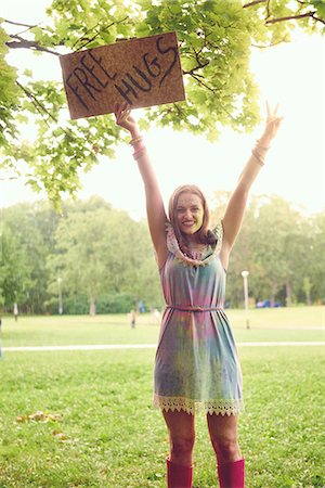 rubber boots woman - Portrait of young woman holding up free hug sign at festival Stock Photo - Premium Royalty-Free, Code: 614-08990448