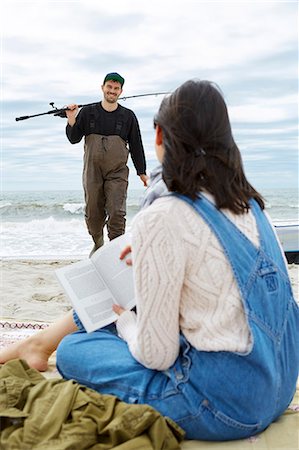 females in hip waders - Young woman looking at sea fishing boyfriend on beach Stock Photo - Premium Royalty-Free, Code: 614-08990753