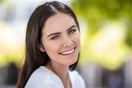 Portrait of young woman, outdoors, smiling Stock Photo - Premium Royalty-Free, Code: 614-08991089