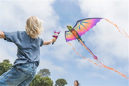 Boy flying kite Stock Photo - Premium Royalty-Free, Code: 614-08991179