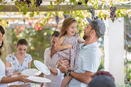 simsearch:614-09017395,k - Man and girl at outdoor family lunch Foto de stock - Royalty Free Premium, Número: 614-09017404