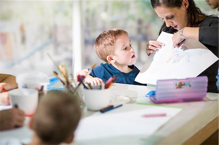 Teacher teaching boy to draw Stock Photo - Premium Royalty-Free, Code: 614-09017453