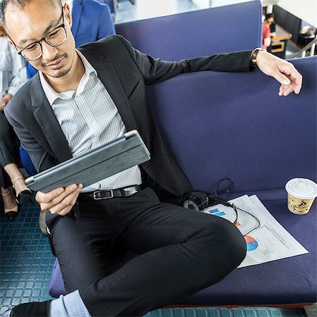 simsearch:614-08926442,k - Cool businessman looking at digital tablet on passenger ferry Stock Photo - Premium Royalty-Free, Code: 614-09017518