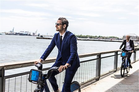 simsearch:614-09017513,k - Young businessman cycling on waterfront, New York, USA Stock Photo - Premium Royalty-Free, Code: 614-09017559