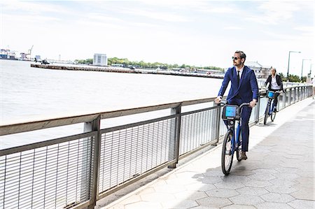 simsearch:614-09017513,k - Young businessman cycling on waterfront, New York, USA Stock Photo - Premium Royalty-Free, Code: 614-09017567