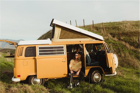Young male skateboarder looking out from vintage recreational vehicle, Exeter, California, USA Stock Photo - Premium Royalty-Free, Code: 614-09026453