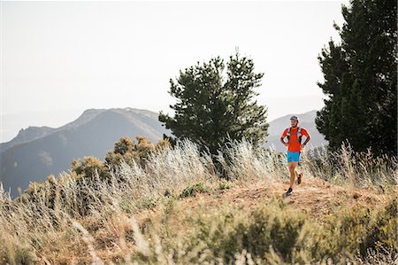 simsearch:614-08392519,k - Man running outdoors in rural, hilly setting, Santa Barbara, California, USA Stock Photo - Premium Royalty-Free, Code: 614-09026531