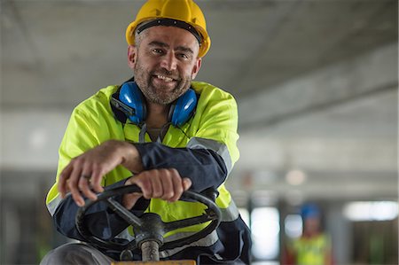 safety construction - Construction worker at steering wheel of vehicle Stock Photo - Premium Royalty-Free, Code: 614-09026614