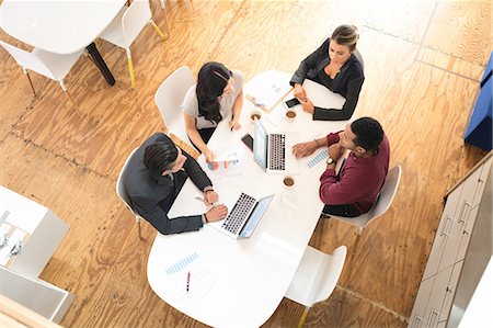Overhead view of business team meeting at office table Stock Photo - Premium Royalty-Free, Code: 614-09026833
