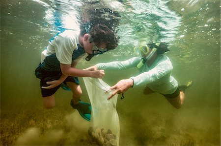 sports and swimming children boy - Mother and son hunting scallops together Stock Photo - Premium Royalty-Free, Code: 614-09027206