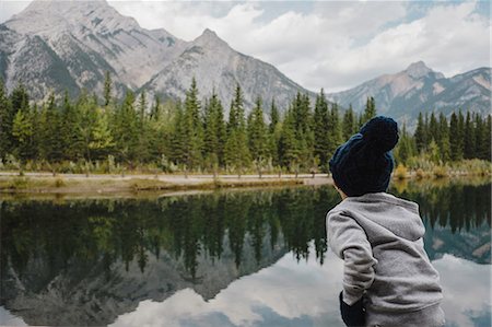 simsearch:614-08487786,k - Boy looking at reflection of mountain and trees in lake, Canmore, Canada, North America Stock Photo - Premium Royalty-Free, Code: 614-09027229