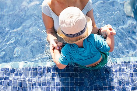 punta cana - Mother and young son in outdoor swimming pool, elevated view, mid section Stock Photo - Premium Royalty-Free, Code: 614-09038635