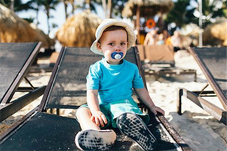 punta cana - Portrait of young boy sitting on sun lounger Stock Photo - Premium Royalty-Free, Code: 614-09038638