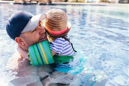 punta cana - Father and daughter in outdoor swimming pool, daughter hugging father Stock Photo - Premium Royalty-Free, Code: 614-09038631