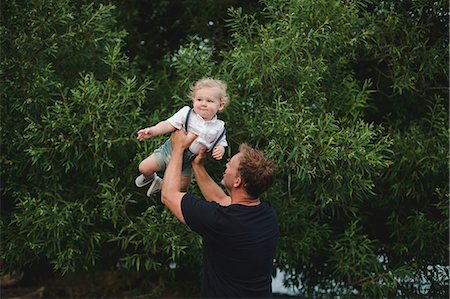 simsearch:614-09038702,k - Mature man lifting up toddler son Photographie de stock - Premium Libres de Droits, Code: 614-09038705
