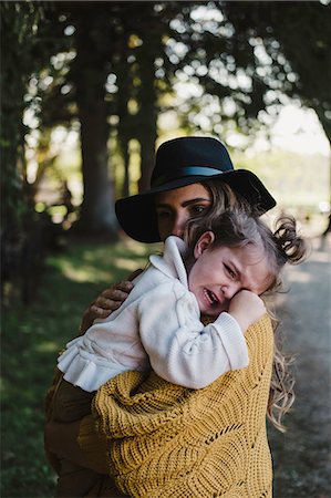 sad child hug mother - Mother comforting upset crying girl Stock Photo - Premium Royalty-Free, Code: 614-09039046