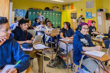 Class of teenage boys and girls doing schoolwork at classroom desks Stock Photo - Premium Royalty-Free, Code: 614-09056542