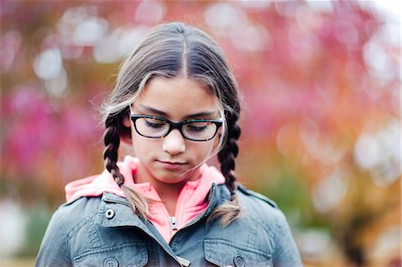 simsearch:614-08872581,k - Portrait of girl with plaits and glasses looking down Fotografie stock - Premium Royalty-Free, Codice: 614-09056680