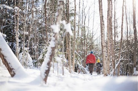 photos two boys walking in the snow - Rear view of man and son in snow covered forest Stock Photo - Premium Royalty-Free, Code: 614-09056743