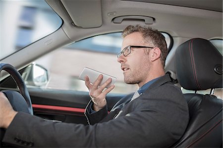 simsearch:614-08877313,k - Businessman driving car, speaking into smartphone Stock Photo - Premium Royalty-Free, Code: 614-09056808