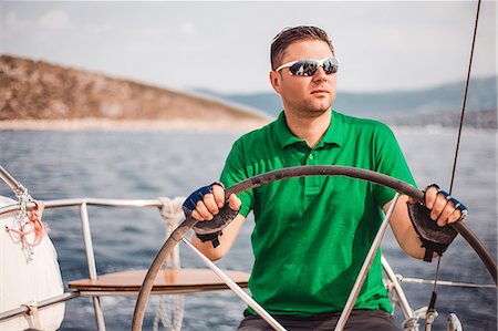 Man sailing sailboat Stock Photo - Premium Royalty-Free, Code: 614-09056898