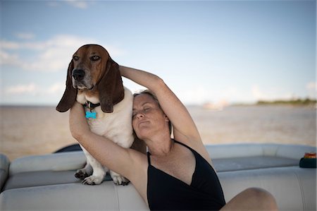 Woman and pet dog relaxing on boat Stock Photo - Premium Royalty-Free, Code: 614-09056930