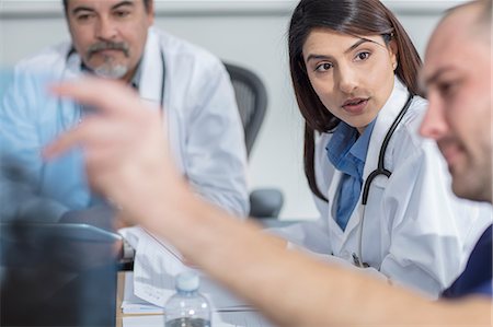 simsearch:649-07761045,k - Group of doctors sitting at table, discussion patient's x-ray Stock Photo - Premium Royalty-Free, Code: 614-09057369