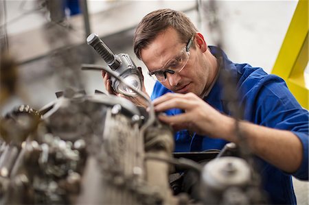 simsearch:614-09057420,k - Car mechanic inspecting car part in repair garage Stock Photo - Premium Royalty-Free, Code: 614-09057402