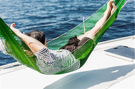 simsearch:614-09078703,k - Man in hammock on sail boat Stockbilder - Premium RF Lizenzfrei, Bildnummer: 614-09078705