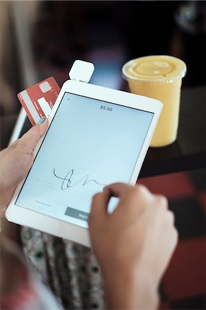 simsearch:649-07520743,k - Close up of young woman's hands signing digital tablet Photographie de stock - Premium Libres de Droits, Code: 614-09078772