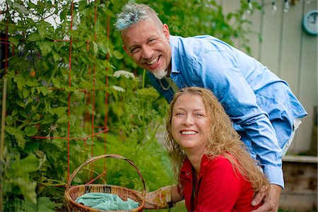Portrait of mature gardening couple by tomato plants in garden Stock Photo - Premium Royalty-Free, Code: 614-09078786