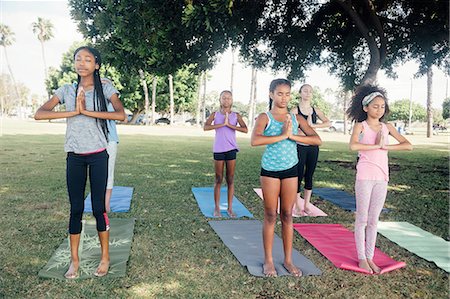 simsearch:614-07194338,k - Girls and teenage schoolgirls practicing yoga mountain pose on school playing field Stock Photo - Premium Royalty-Free, Code: 614-09078923